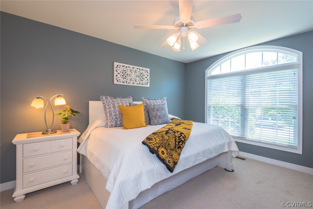 11616 Hillside Road Chester, VA 23831 - Photo 24 of 42 a bedroom with a bed and a chandelier