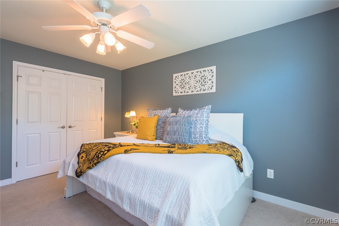 11616 Hillside Road Chester, VA 23831 - Photo 26 of 42 a bedroom with a bed and a chandelier