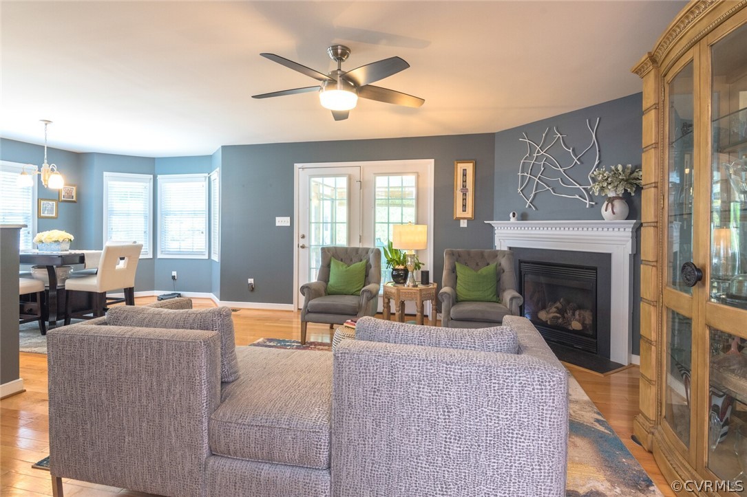 11616 Hillside Road Chester, VA 23831 - Photo 7 of 42 a living room with furniture a fireplace and a large window