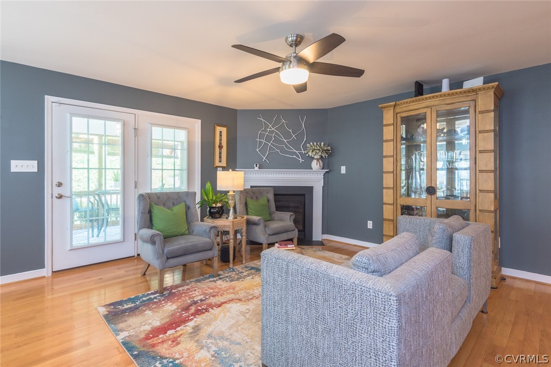 11616 Hillside Road Chester, VA 23831 - Photo 8 of 42 a living room with furniture a fireplace and a floor to ceiling window