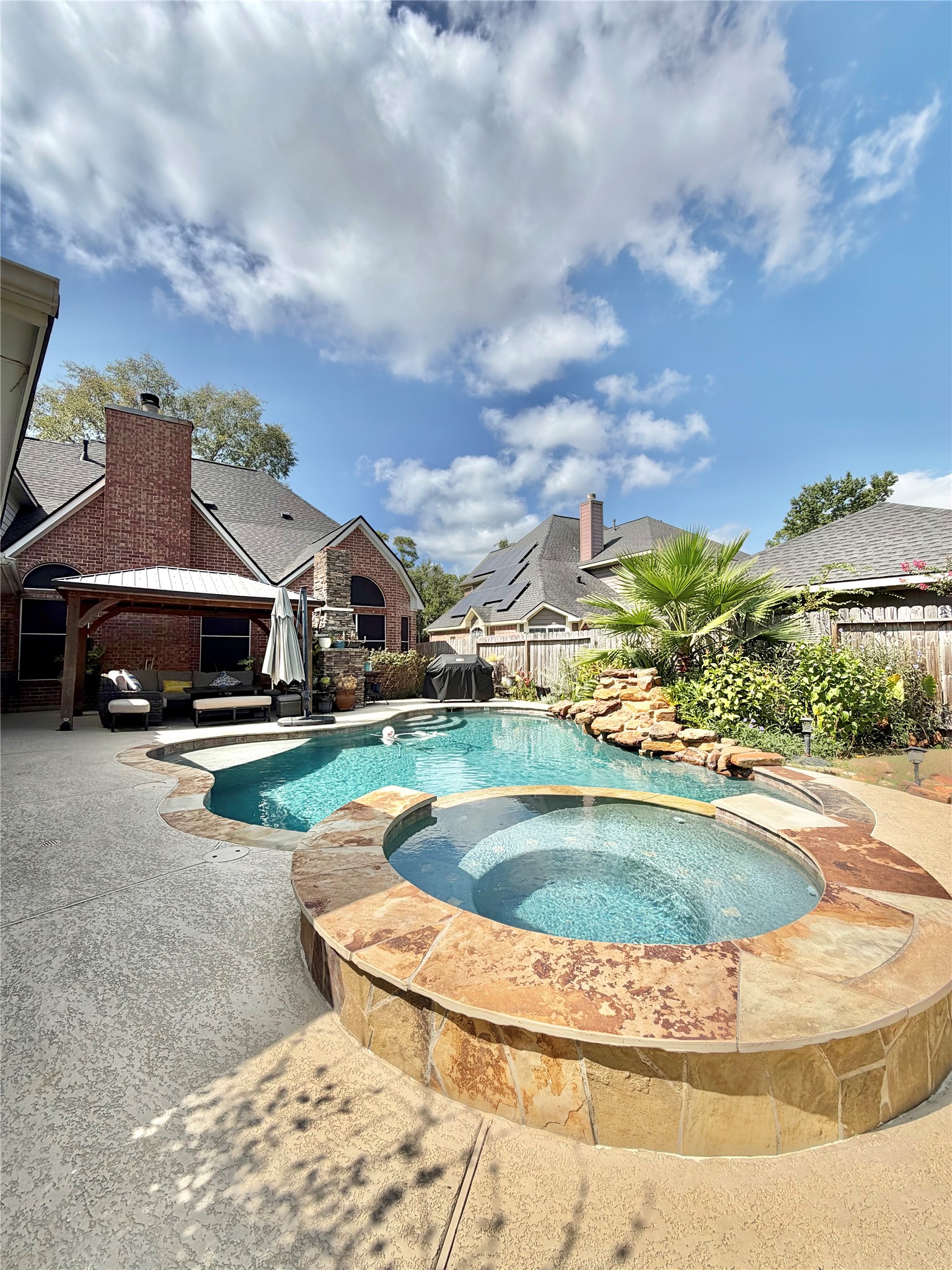 20110 Forest Drive Spring, TX 77388 - Photo 40 of 43 Experience luxury living with this stunning backyard oasis featuring a sparkling pool, soothing spa, and lush landscaping, perfect for relaxation and entertaining.