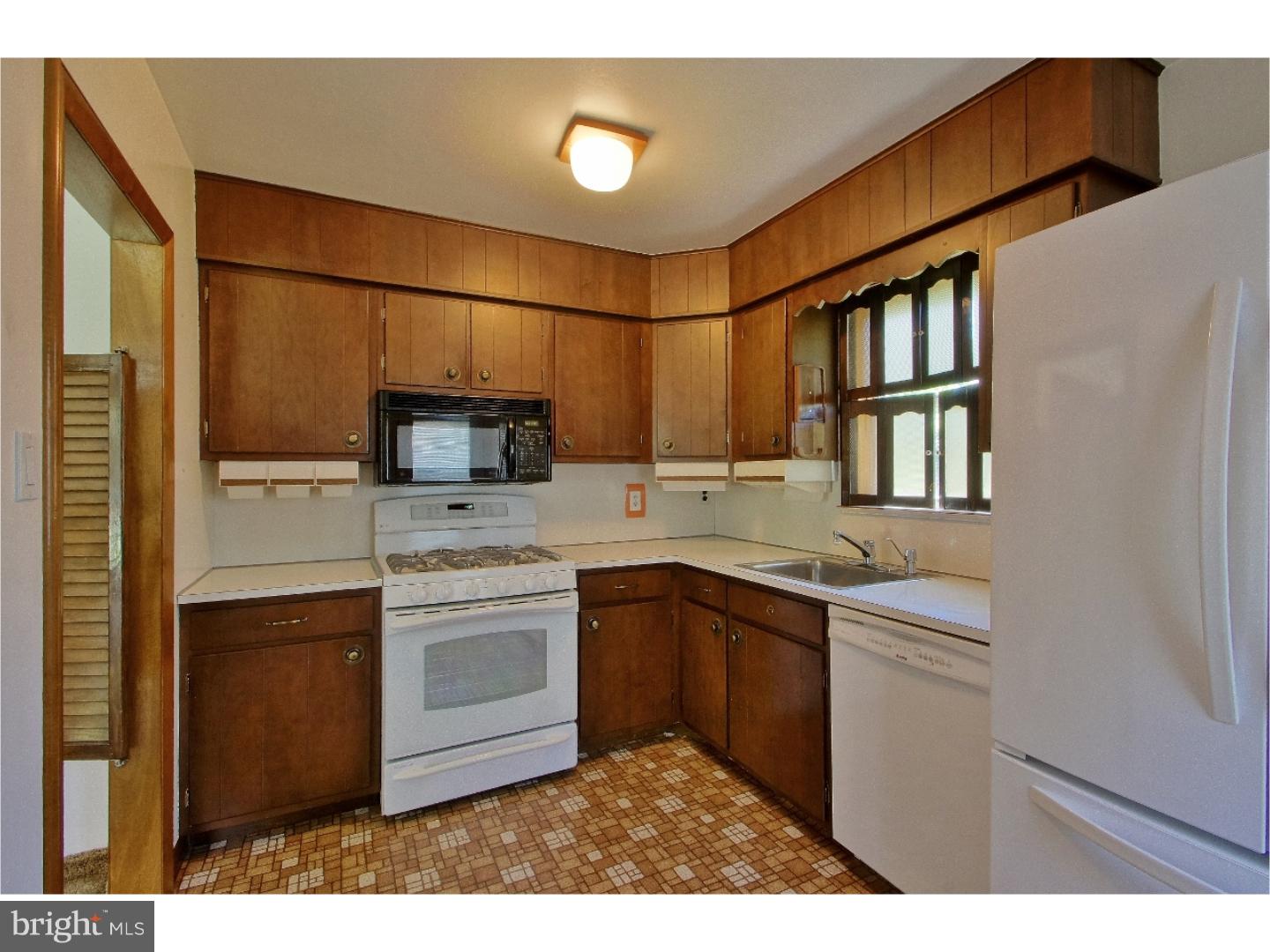 908 Scotia Road Philadelphia, PA 19128 - Photo 11 of 18 a kitchen with a sink stainless steel appliances and cabinets