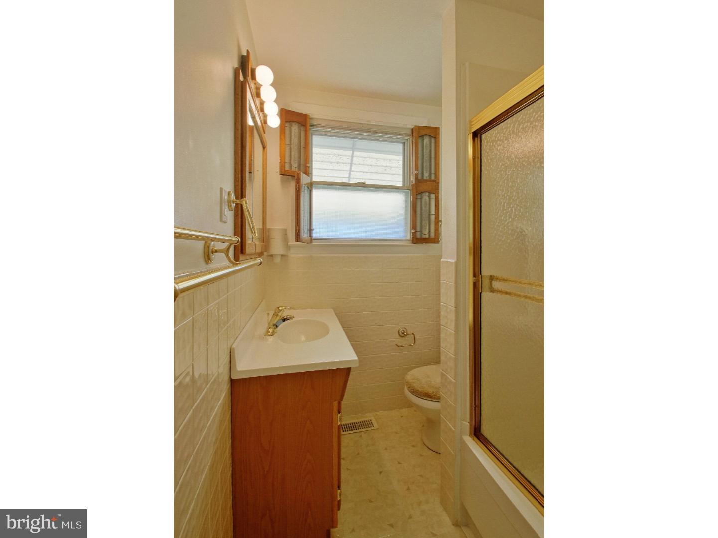 908 Scotia Road Philadelphia, PA 19128 - Photo 15 of 18 a bathroom with a sink a toilet and shower