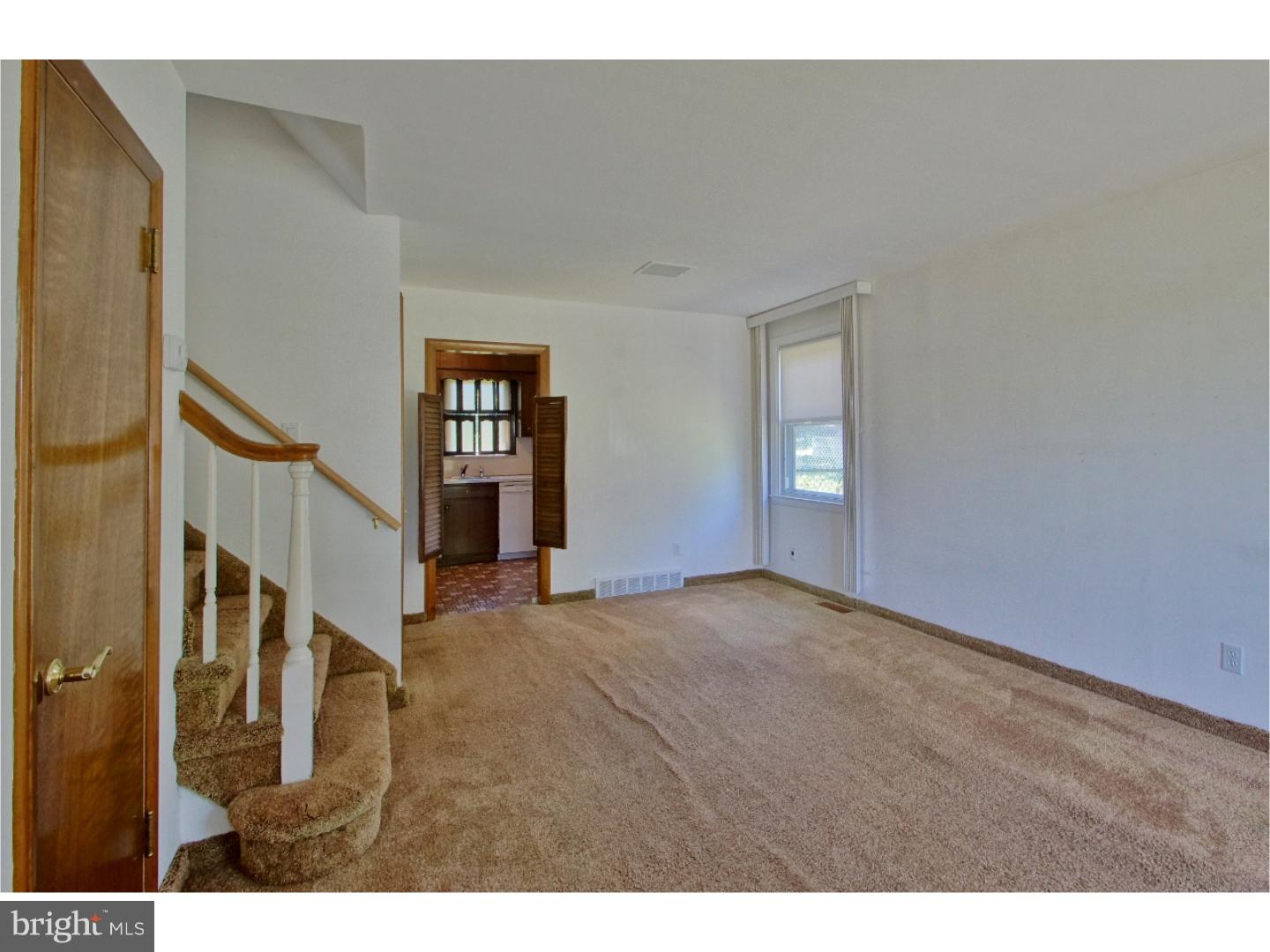 908 Scotia Road Philadelphia, PA 19128 - Photo 6 of 18 a view of an empty room with wooden floor and stairs