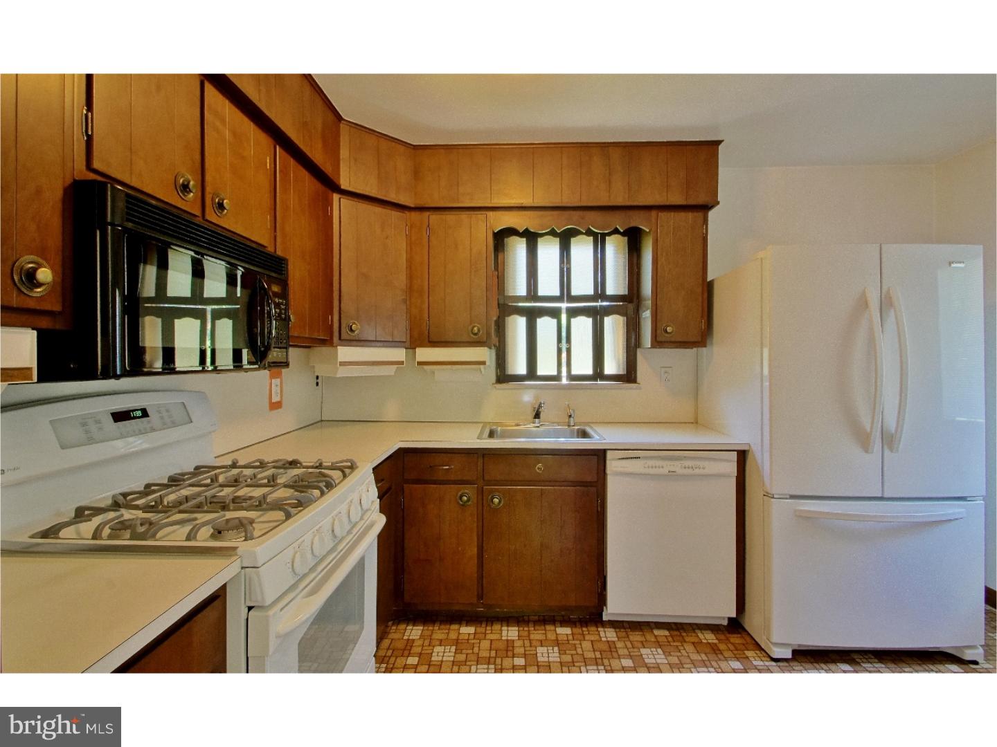 908 Scotia Road Philadelphia, PA 19128 - Photo 10 of 18 a kitchen with a refrigerator and a sink