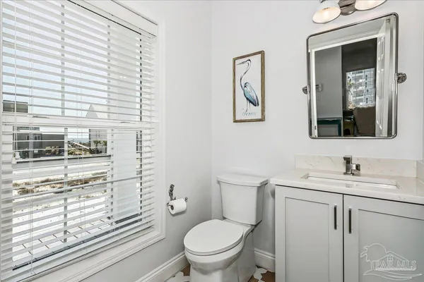 a bathroom with a toilet a sink and a window