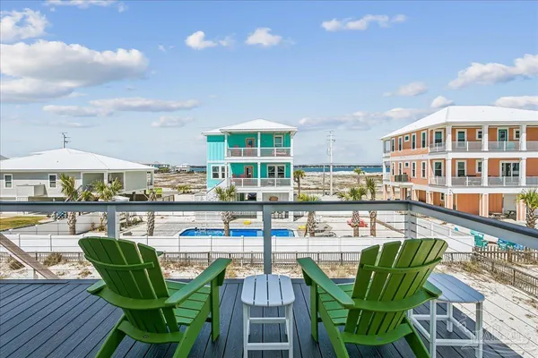 a view of a swimming pool with outdoor seating