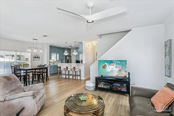 a living room with furniture and wooden floor