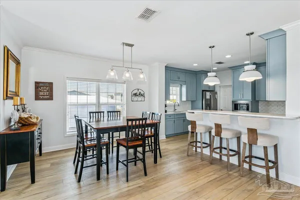 a view of a dining area with furniture and wooden floor