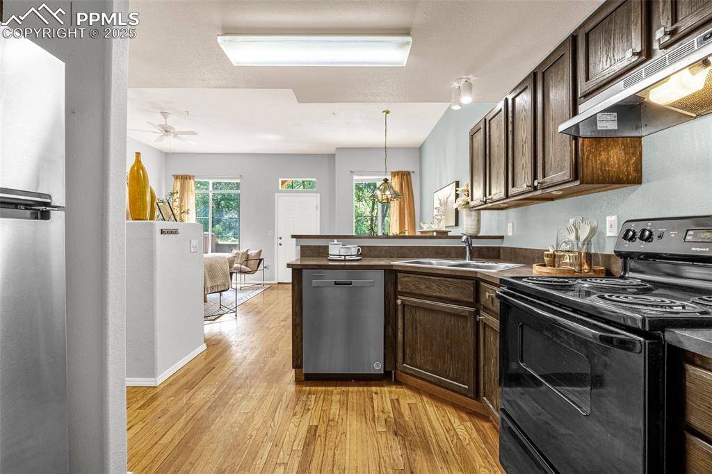 3254 Apogee View Colorado Springs, CO 80906 - Photo 12 of 28 a kitchen with stainless steel appliances granite countertop a stove and a sink