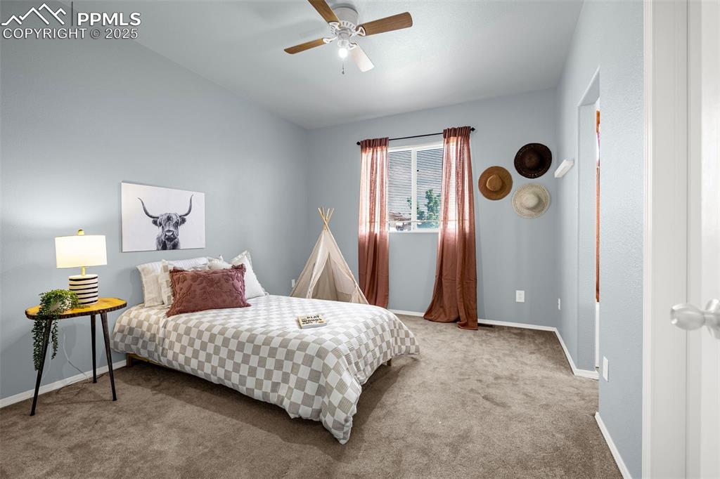 3254 Apogee View Colorado Springs, CO 80906 - Photo 15 of 28 a bedroom with a bed and a window