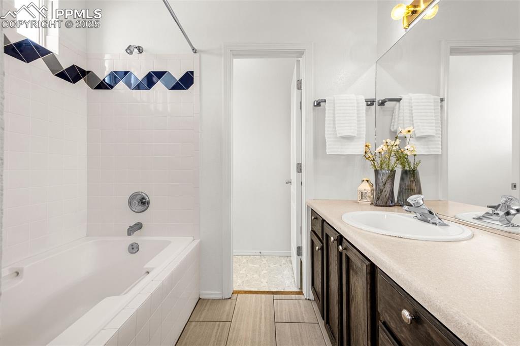 3254 Apogee View Colorado Springs, CO 80906 - Photo 18 of 28 a bathroom with a tub sink and mirror