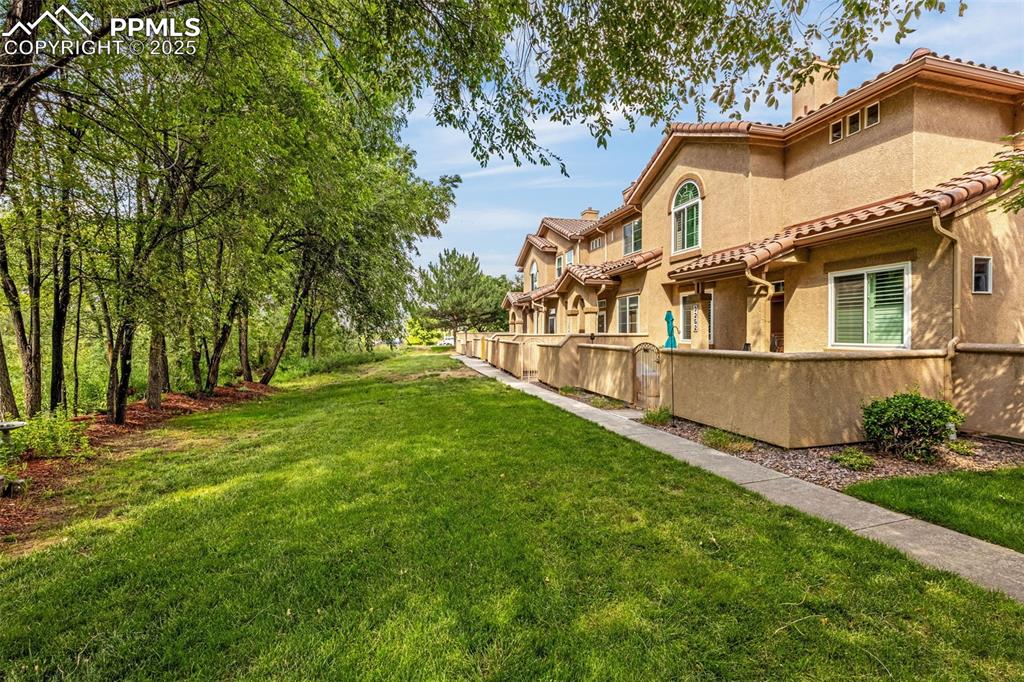 3254 Apogee View Colorado Springs, CO 80906 - Photo 2 of 28 a view of a house with a yard