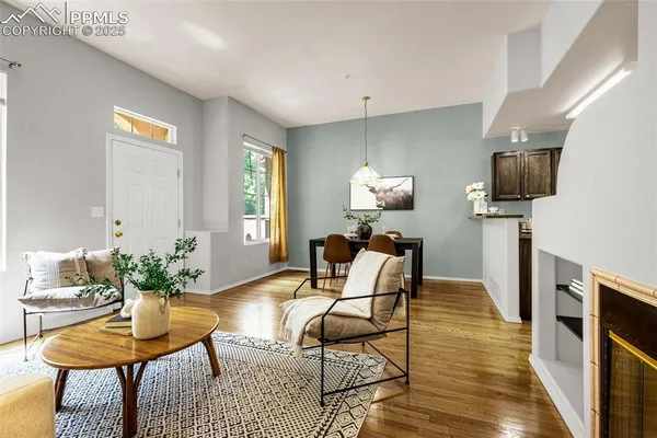 a living room with furniture a fireplace and a table