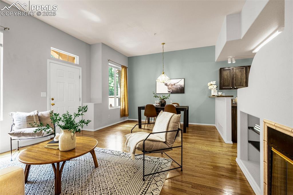 3254 Apogee View Colorado Springs, CO 80906 - Photo 4 of 28 a living room with furniture a fireplace and a table