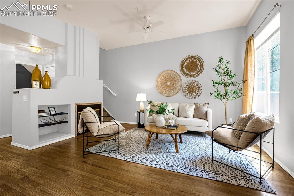 3254 Apogee View Colorado Springs, CO 80906 - Photo 7 of 28 a living room with furniture wooden floor and a large window