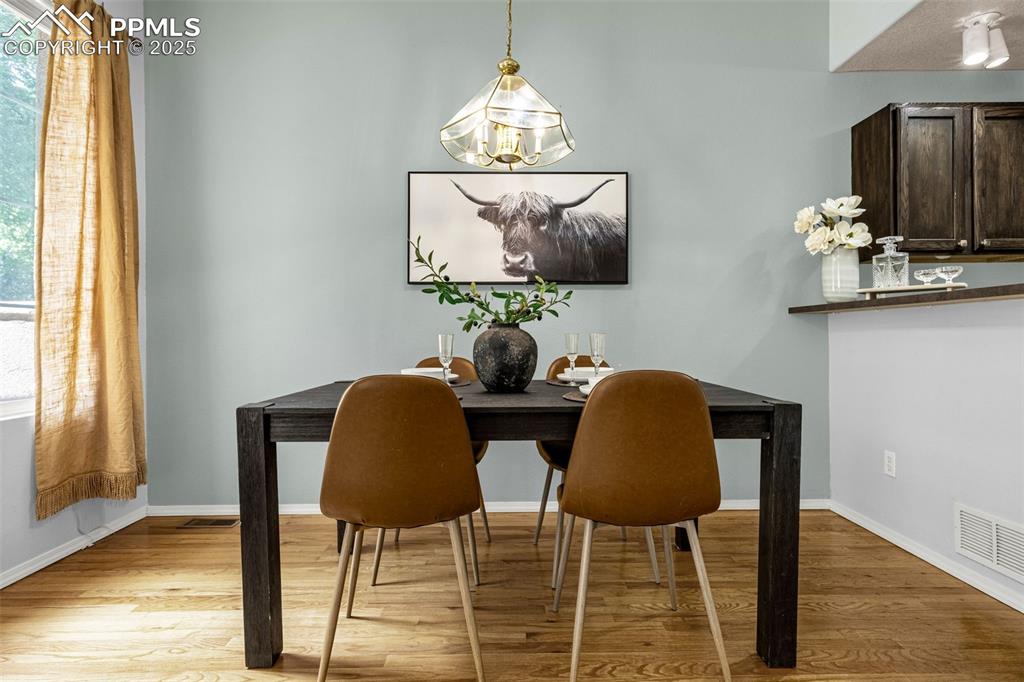 3254 Apogee View Colorado Springs, CO 80906 - Photo 8 of 28 a dining room table with chairs and window