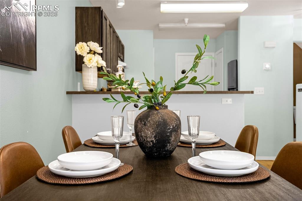 3254 Apogee View Colorado Springs, CO 80906 - Photo 9 of 28 a view of a dining room with furniture and a potted plant