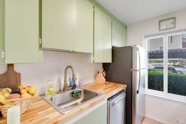 a kitchen with a refrigerator and a sink