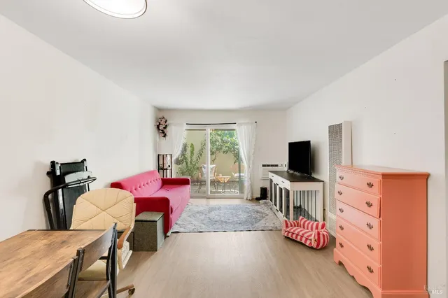 a bedroom with furniture and a flat screen tv