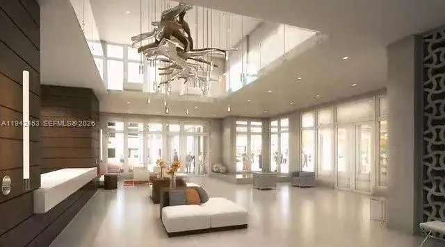 a lobby with furniture and floor to ceiling window