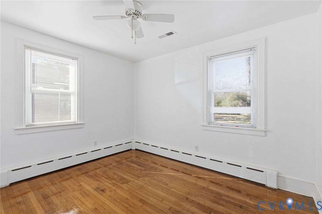 5116 Alberene Road Richmond, VA 23224 - Photo 12 of 20 wooden floor in an empty room with a window
