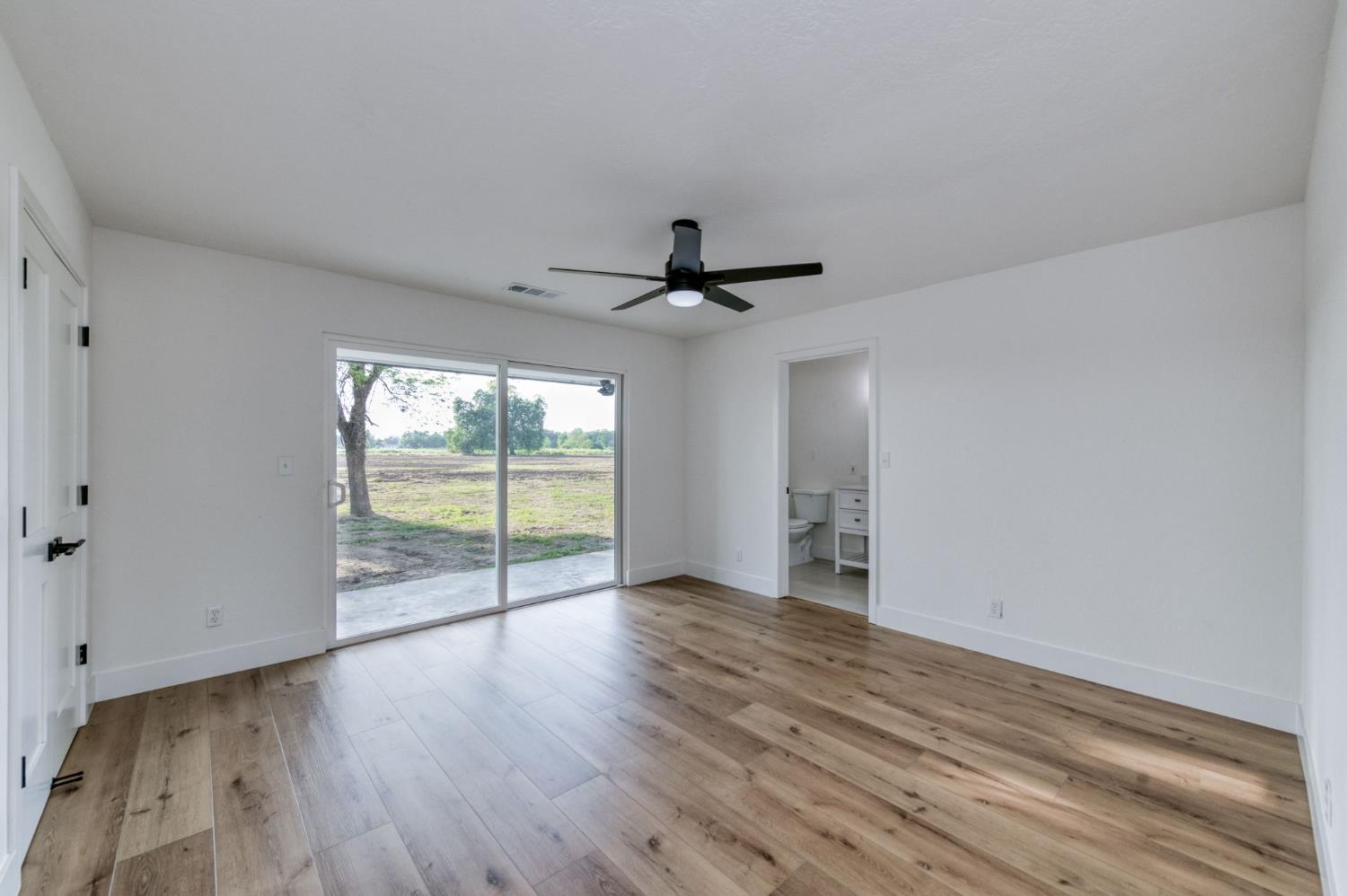 545 North Rio Vista Avenue Sanger, CA 93657 - Photo 11 of 46 a view of empty room with wooden floor and fan