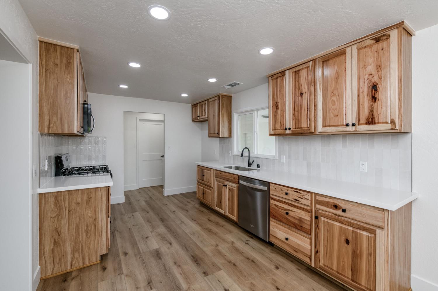 545 North Rio Vista Avenue Sanger, CA 93657 - Photo 14 of 46 a kitchen with stainless steel appliances granite countertop a stove a sink and a refrigerator