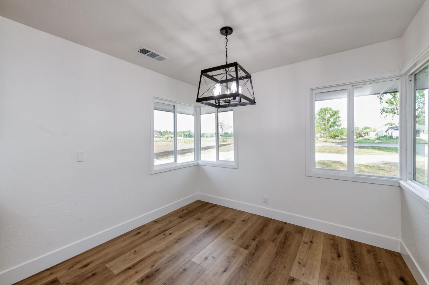 545 North Rio Vista Avenue Sanger, CA 93657 - Photo 15 of 46 a view of empty room with wooden floor and fan