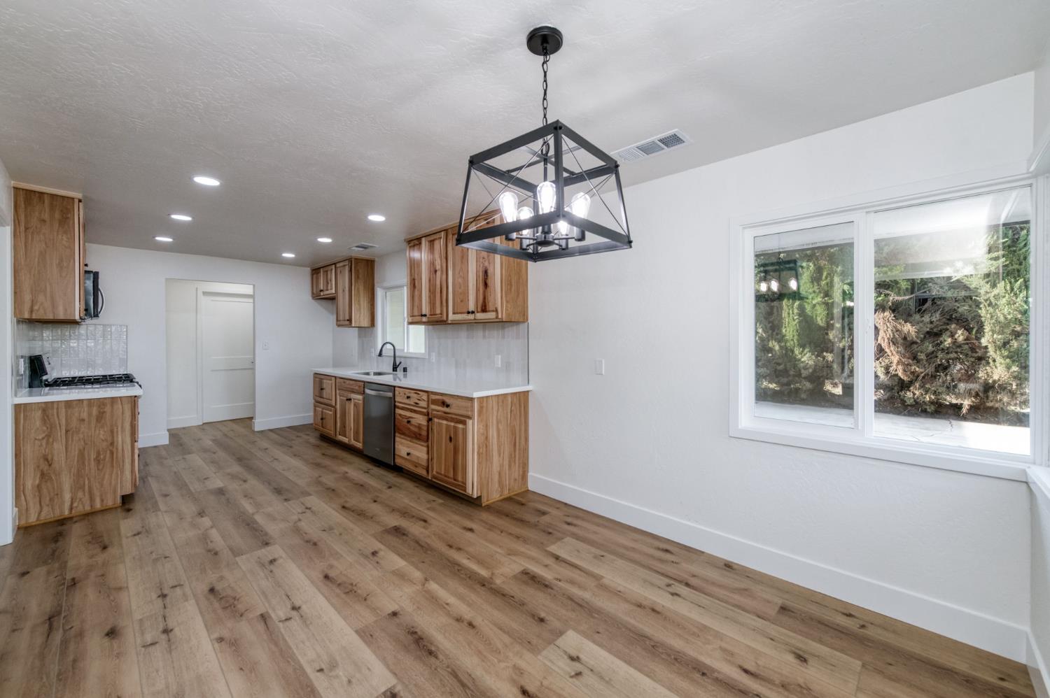 545 North Rio Vista Avenue Sanger, CA 93657 - Photo 28 of 46 a view of a kitchen counter space a sink wooden floor and windows