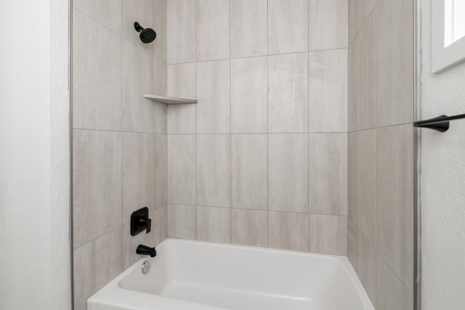 545 North Rio Vista Avenue Sanger, CA 93657 - Photo 31 of 46 a bathroom with a bathtub and a shower