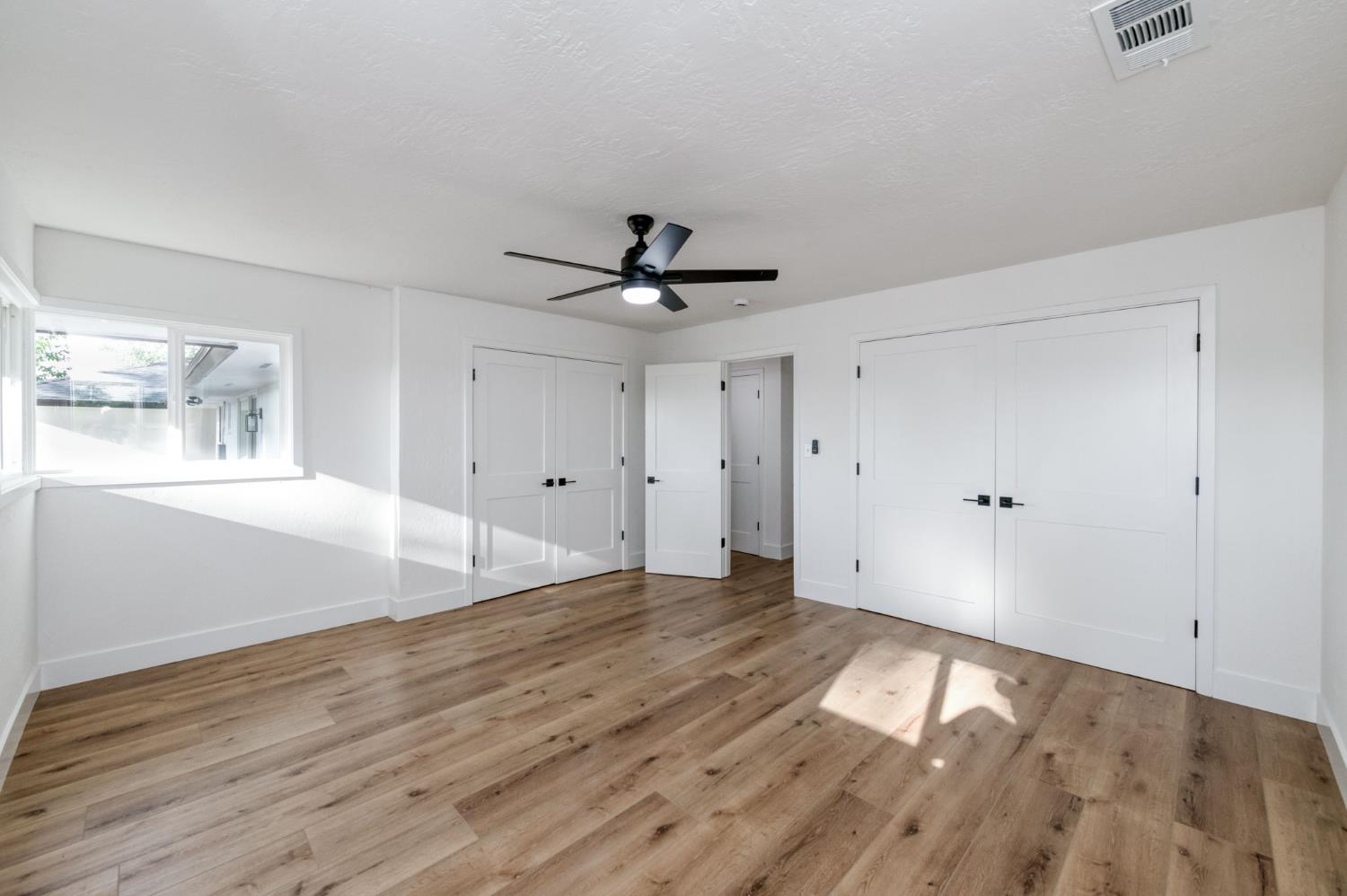 545 North Rio Vista Avenue Sanger, CA 93657 - Photo 32 of 46 a view of empty room with wooden floor and fan