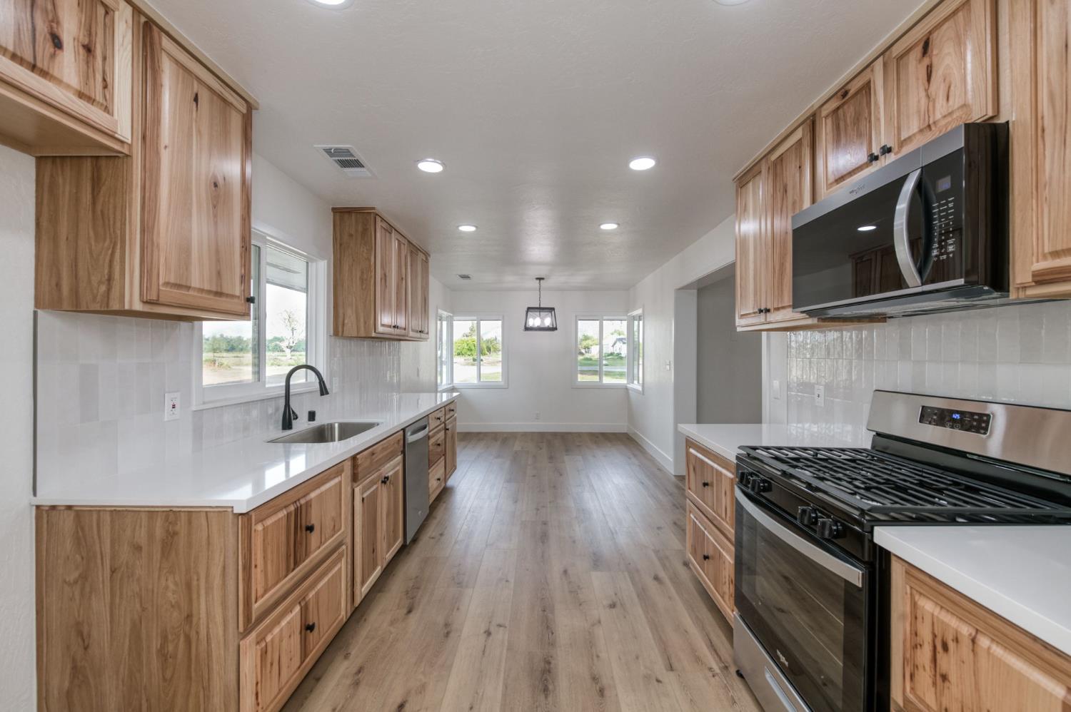 545 North Rio Vista Avenue Sanger, CA 93657 - Photo 6 of 46 a kitchen with stainless steel appliances granite countertop a stove and a sink