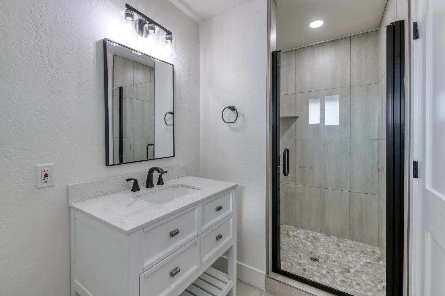 545 North Rio Vista Avenue Sanger, CA 93657 - Photo 7 of 46 a bathroom with a double vanity sink mirror and shower