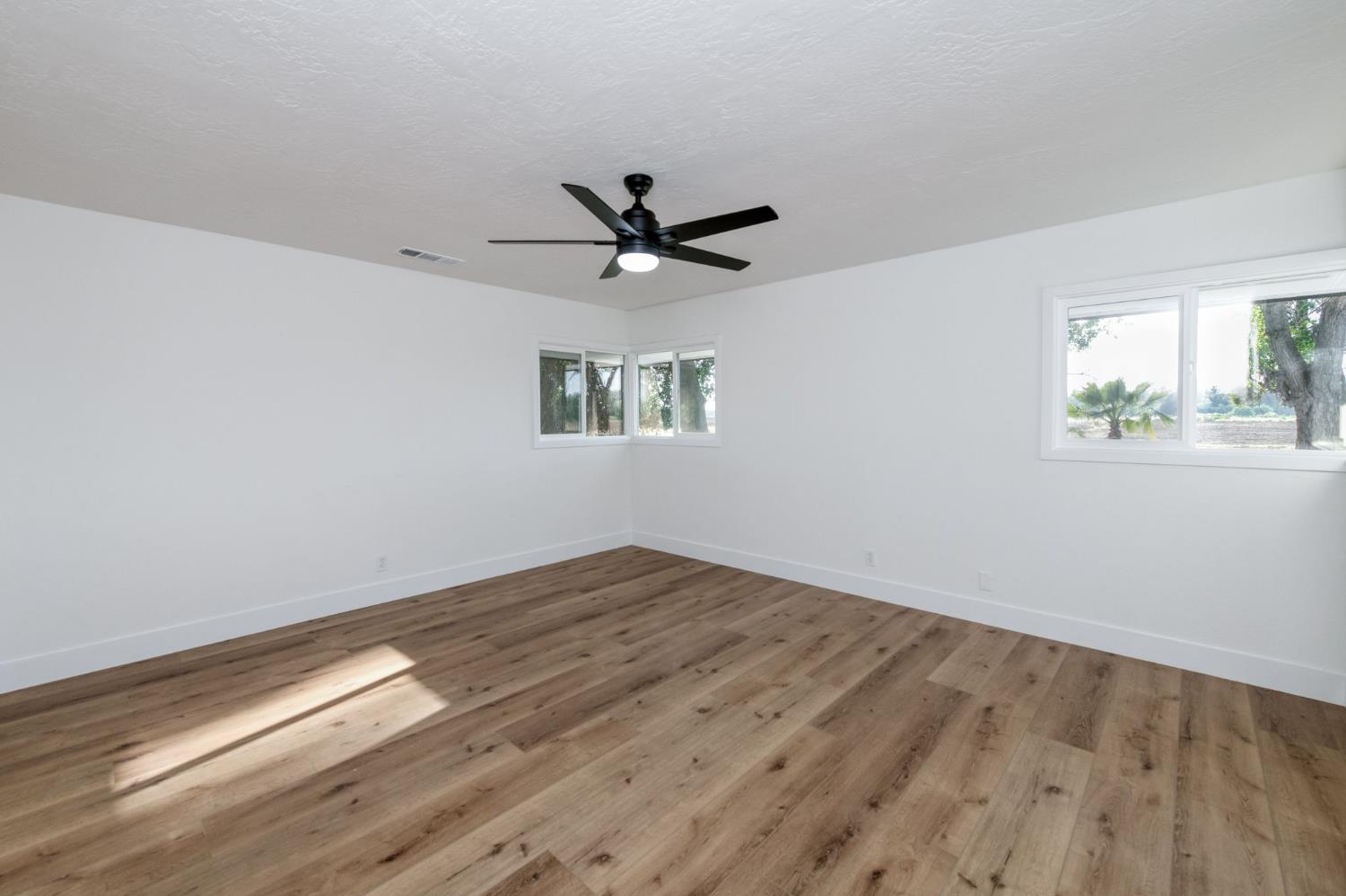 545 North Rio Vista Avenue Sanger, CA 93657 - Photo 9 of 46 wooden floor in an empty room with a window