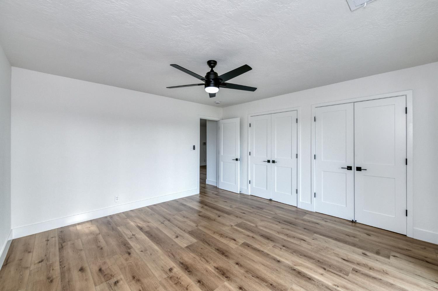 545 North Rio Vista Avenue Sanger, CA 93657 - Photo 10 of 46 a view of empty room with wooden floor and ceiling fan