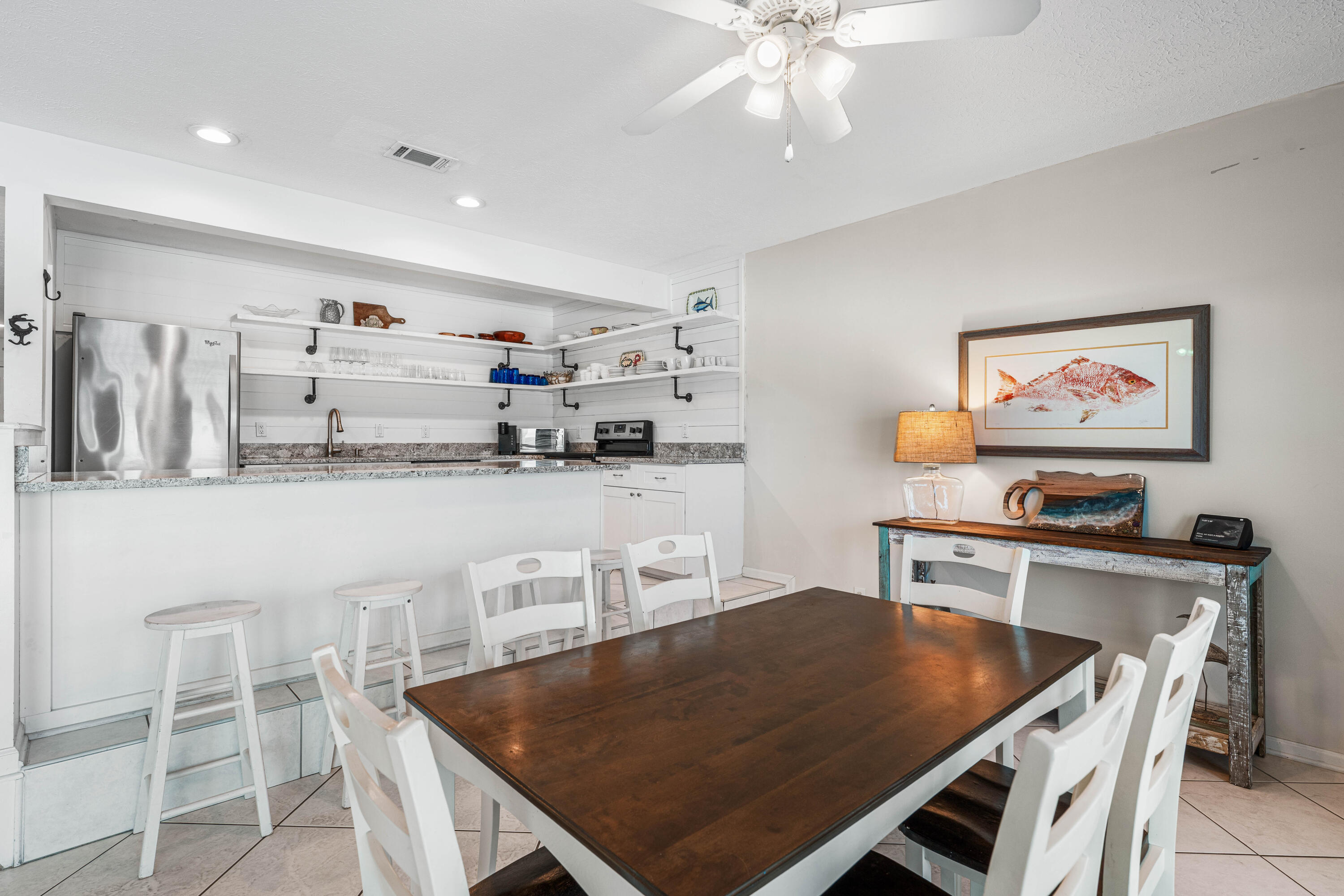 142 Beachside Drive, Unit 7 Santa Rosa Beach, FL 32459 - Photo 11 of 41 a kitchen with stainless steel appliances a stove a table and chairs