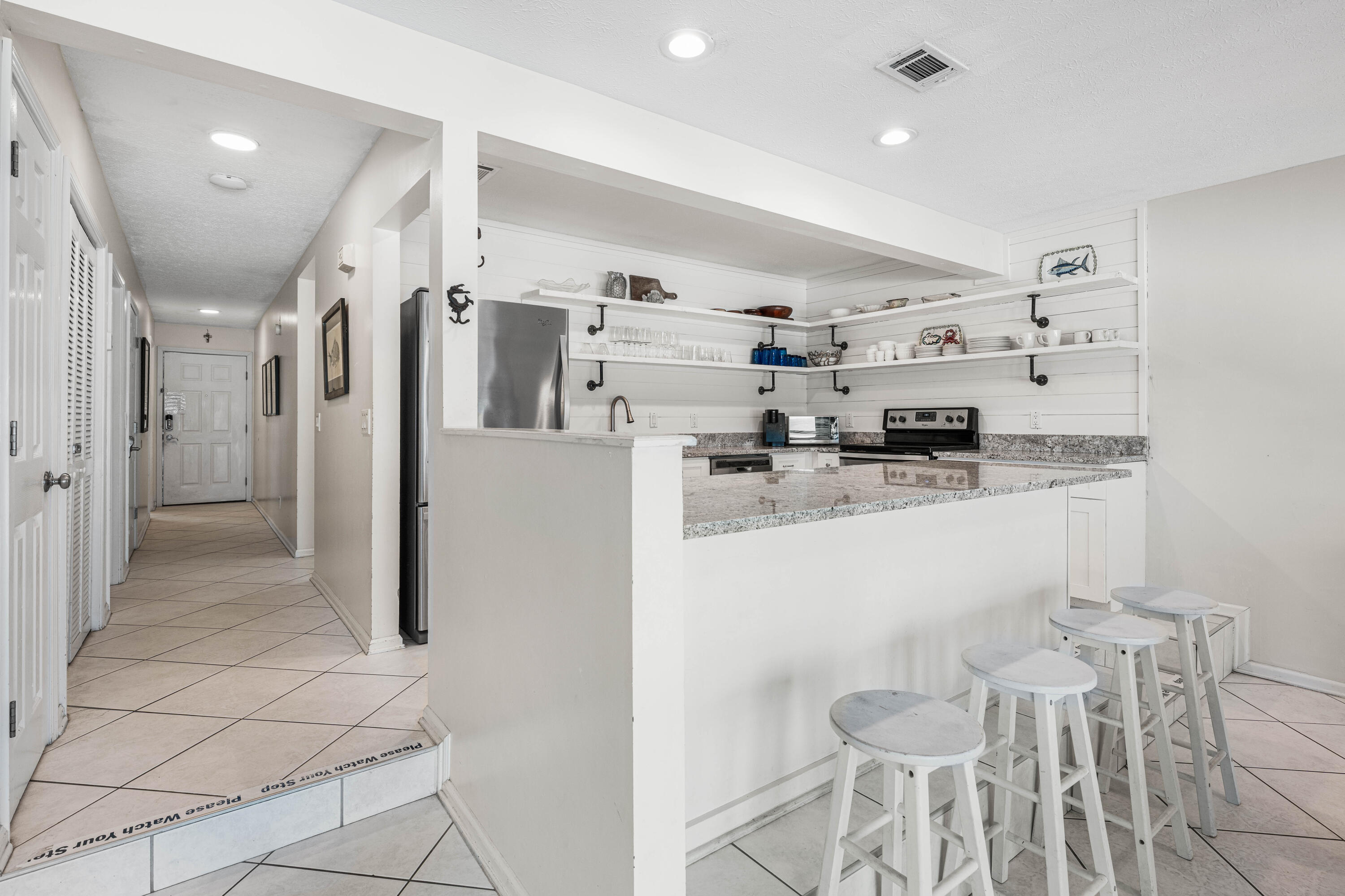 142 Beachside Drive, Unit 7 Santa Rosa Beach, FL 32459 - Photo 12 of 41 a kitchen with stainless steel appliances a refrigerator sink and cabinets