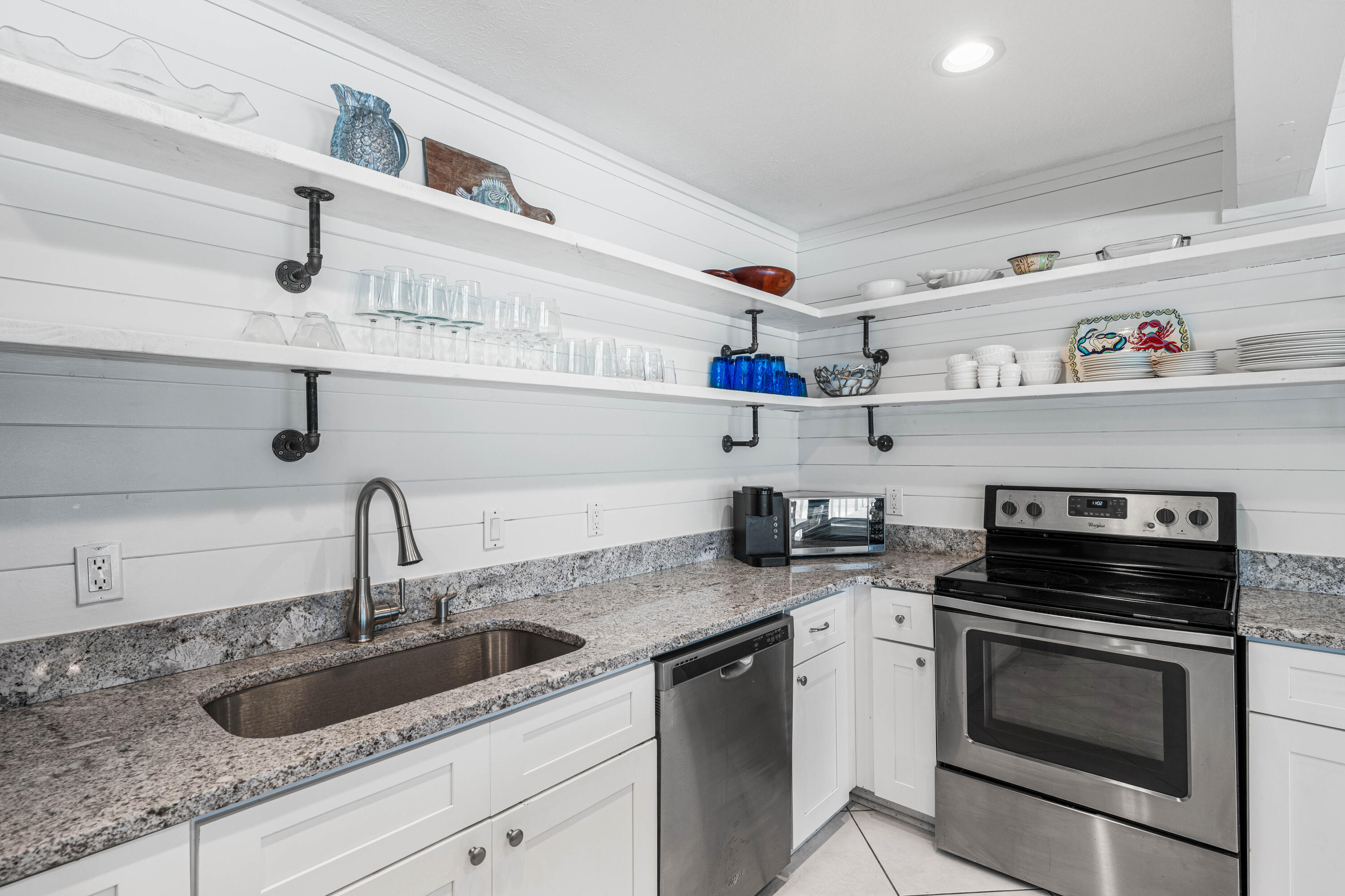 142 Beachside Drive, Unit 7 Santa Rosa Beach, FL 32459 - Photo 13 of 41 a kitchen with cabinets a sink and appliances
