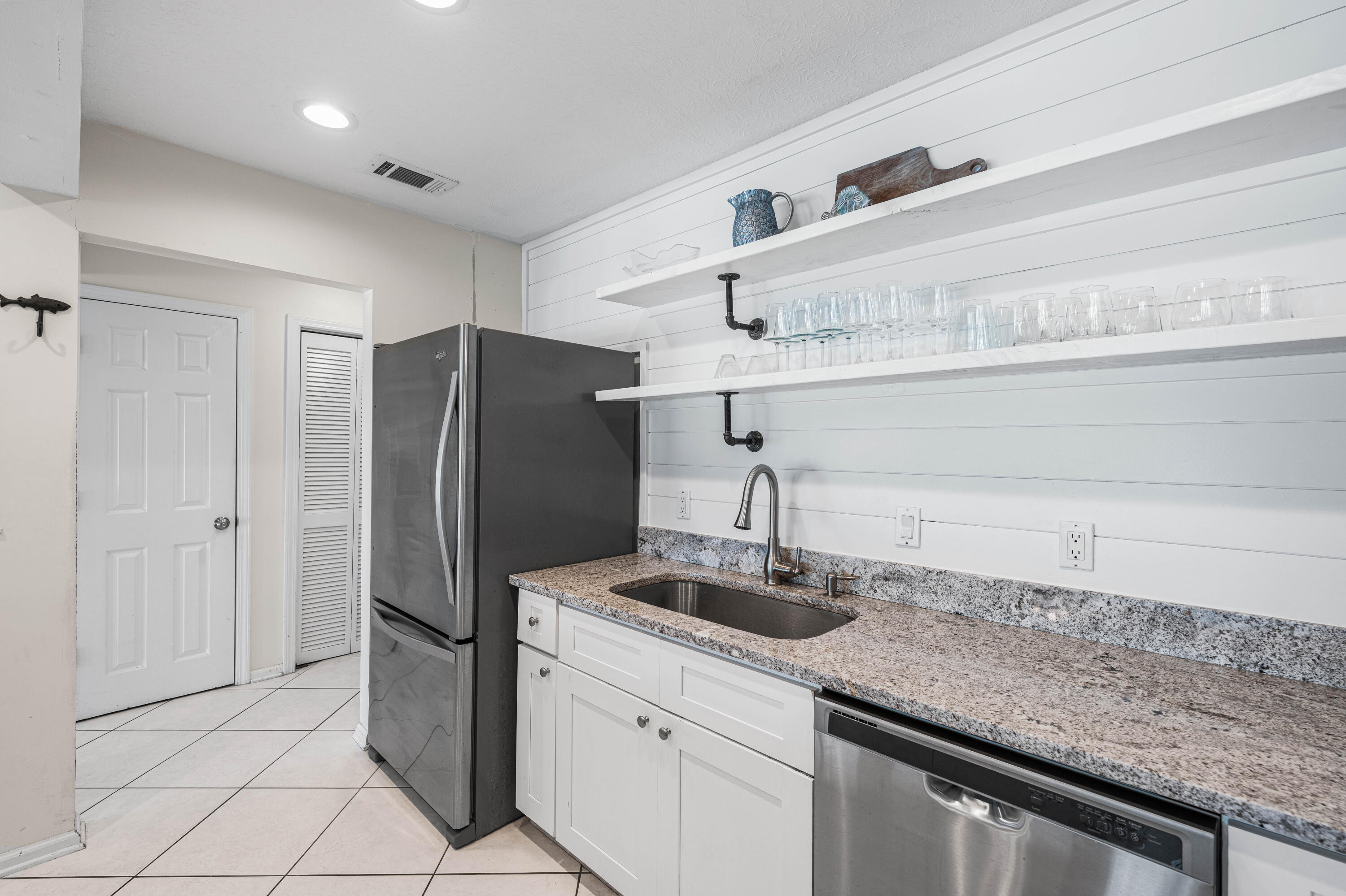 142 Beachside Drive, Unit 7 Santa Rosa Beach, FL 32459 - Photo 14 of 41 a kitchen with stainless steel appliances granite countertop a sink and a refrigerator