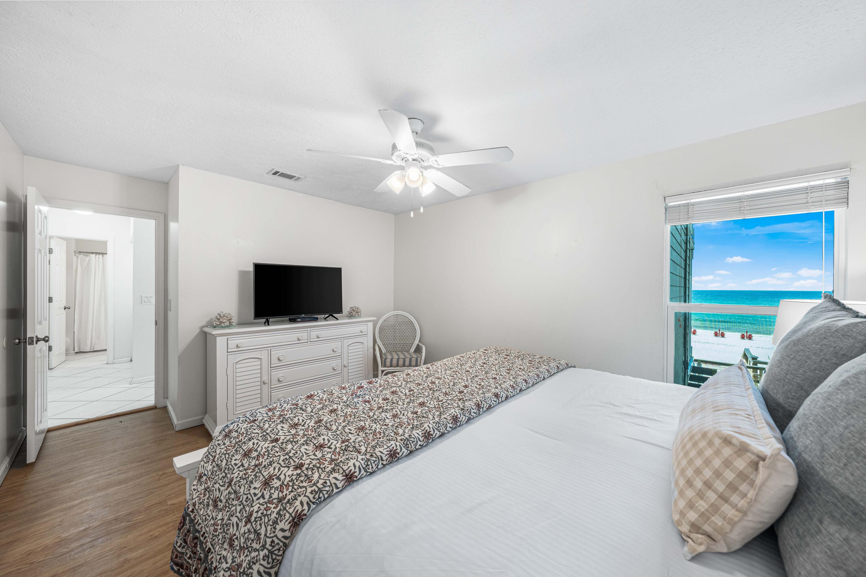 142 Beachside Drive, Unit 7 Santa Rosa Beach, FL 32459 - Photo 17 of 41 a bedroom with a large bed and a flat screen tv