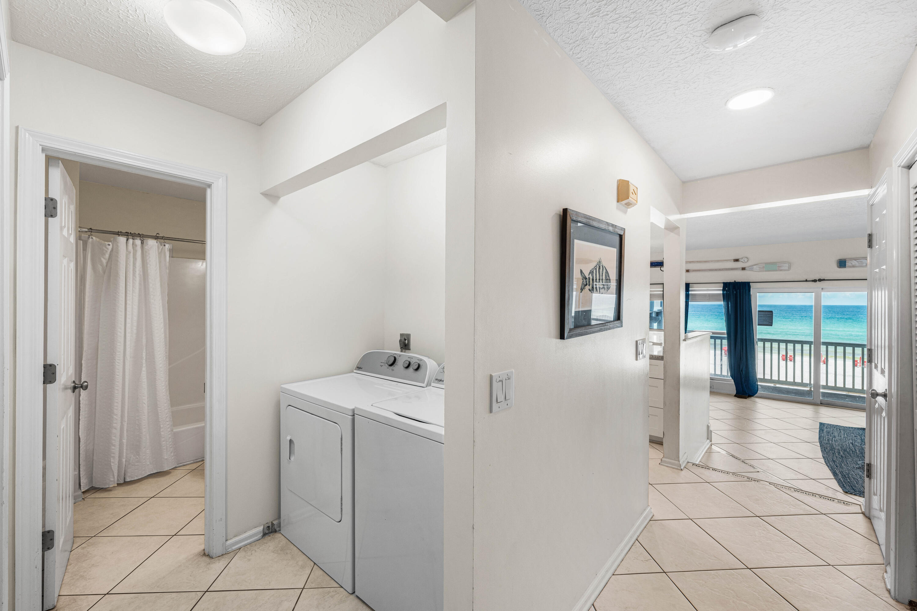 142 Beachside Drive, Unit 7 Santa Rosa Beach, FL 32459 - Photo 22 of 41 a room with white cabinets and washer dryer