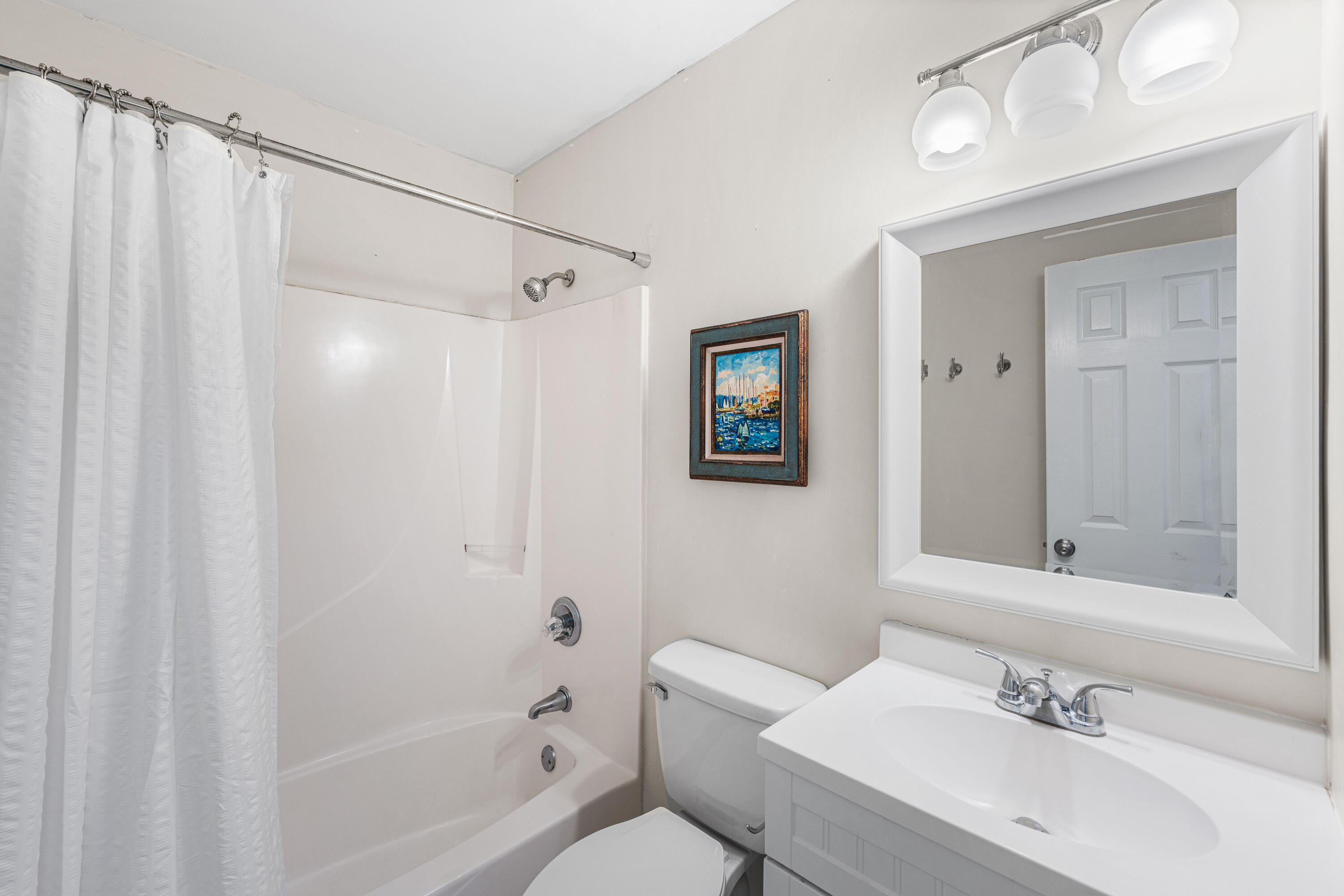 142 Beachside Drive, Unit 7 Santa Rosa Beach, FL 32459 - Photo 23 of 41 a bathroom with a sink mirror and a bathtub