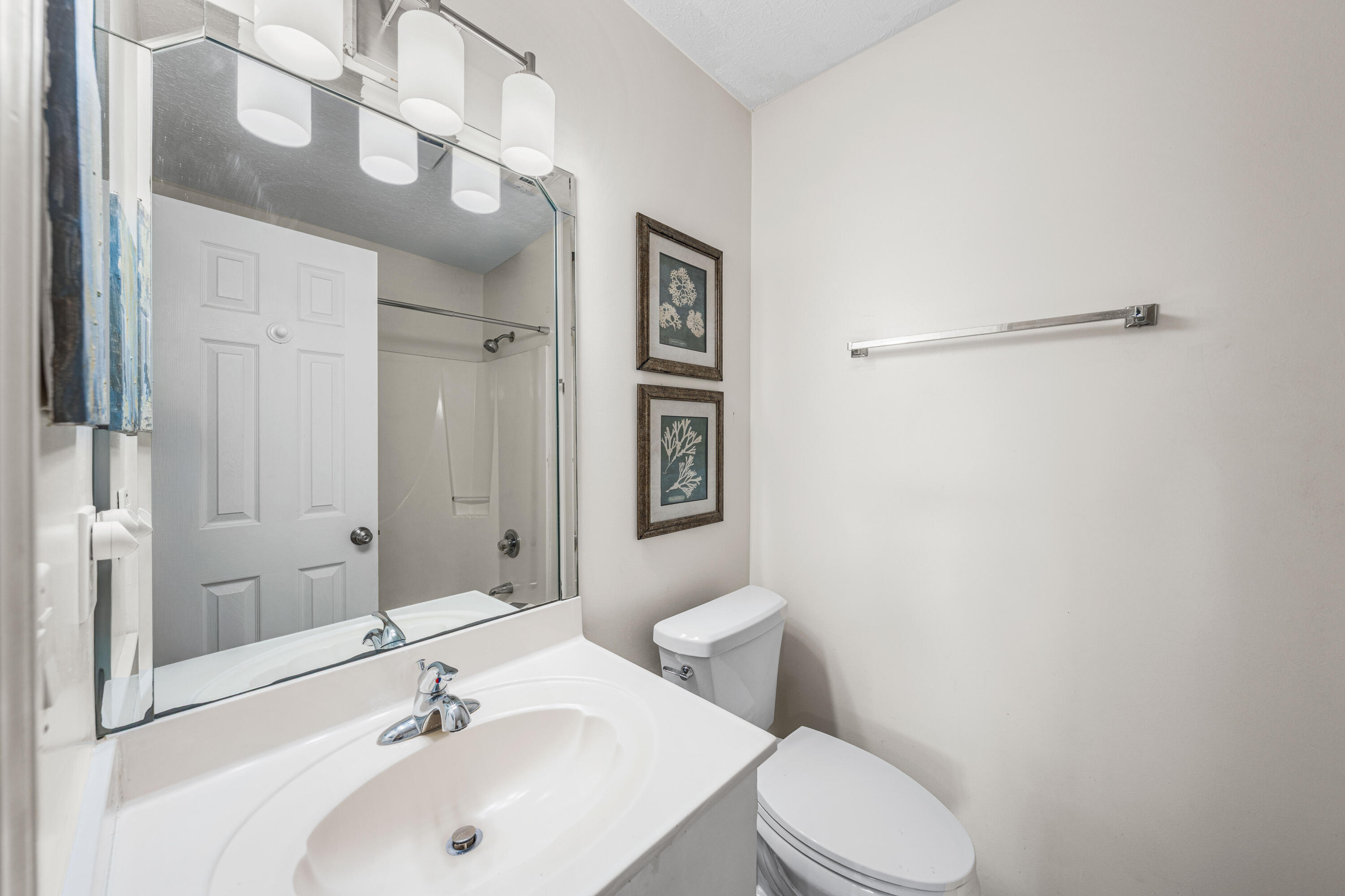 142 Beachside Drive, Unit 7 Santa Rosa Beach, FL 32459 - Photo 26 of 41 a bathroom with a sink mirror vanity and toilet