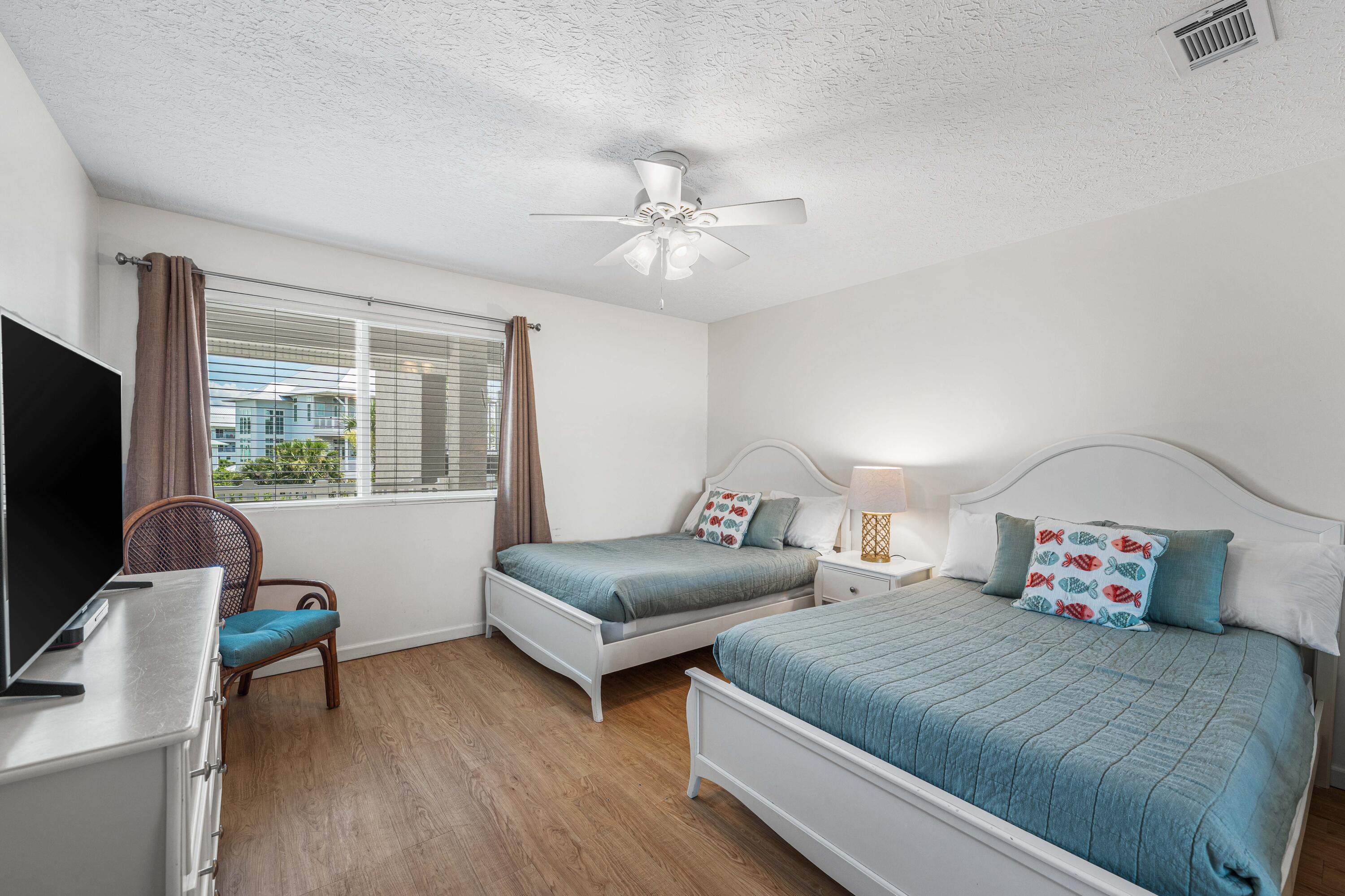 142 Beachside Drive, Unit 7 Santa Rosa Beach, FL 32459 - Photo 28 of 41 a bedroom with two beds and a window