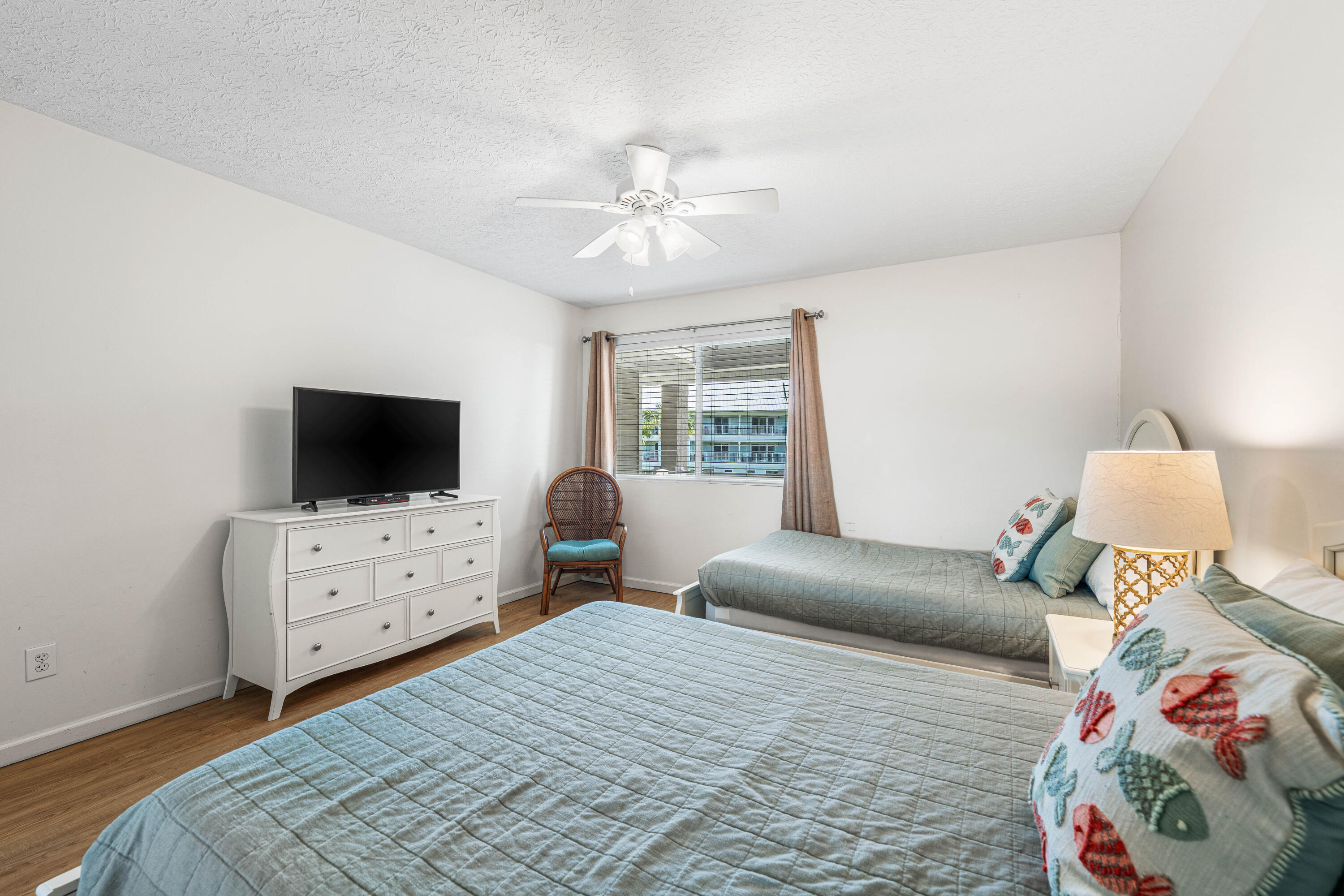 142 Beachside Drive, Unit 7 Santa Rosa Beach, FL 32459 - Photo 29 of 41 a bedroom with a bed and flat screen tv