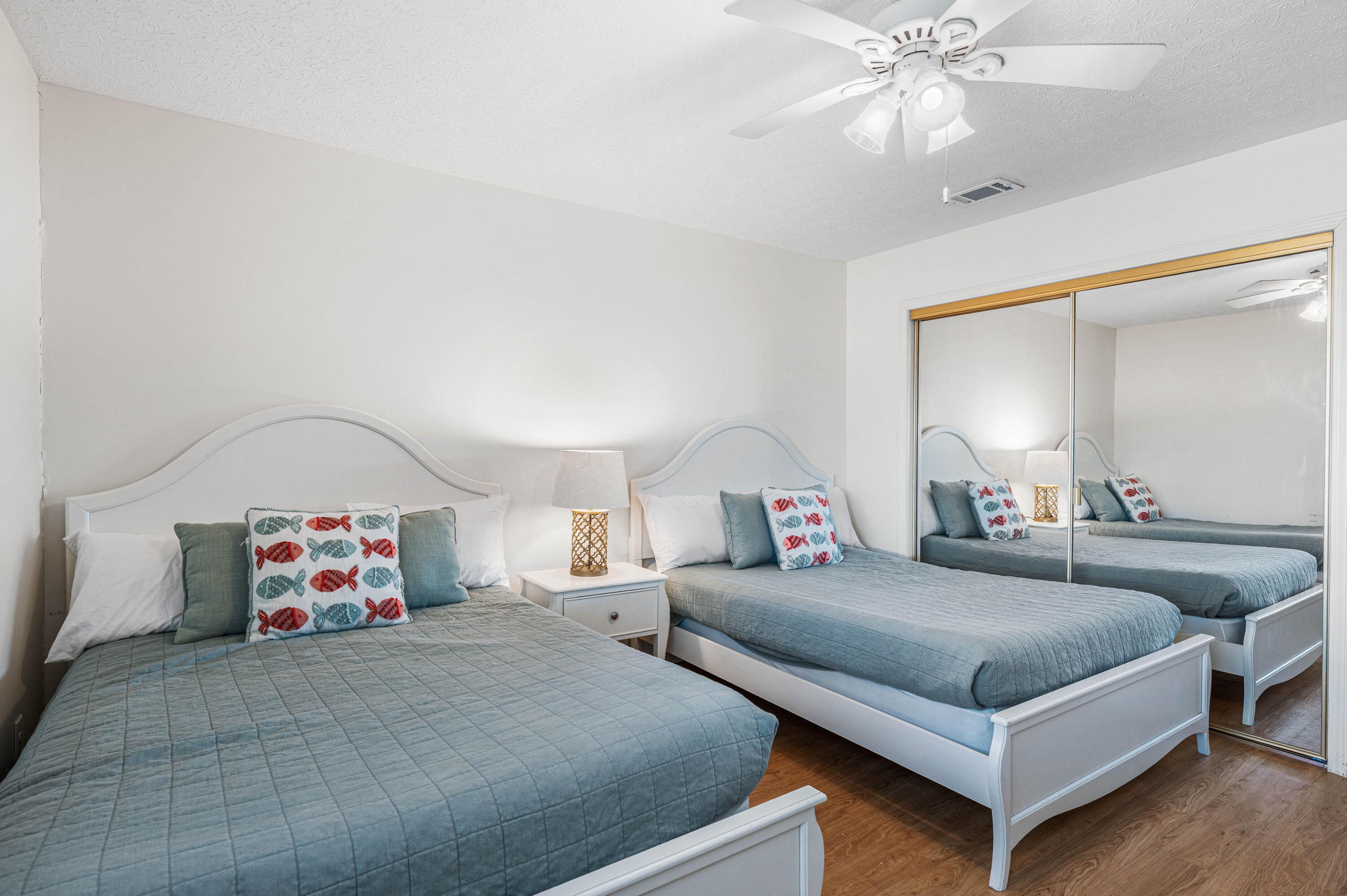 142 Beachside Drive, Unit 7 Santa Rosa Beach, FL 32459 - Photo 30 of 41 a bedroom with a large bed and a chandelier