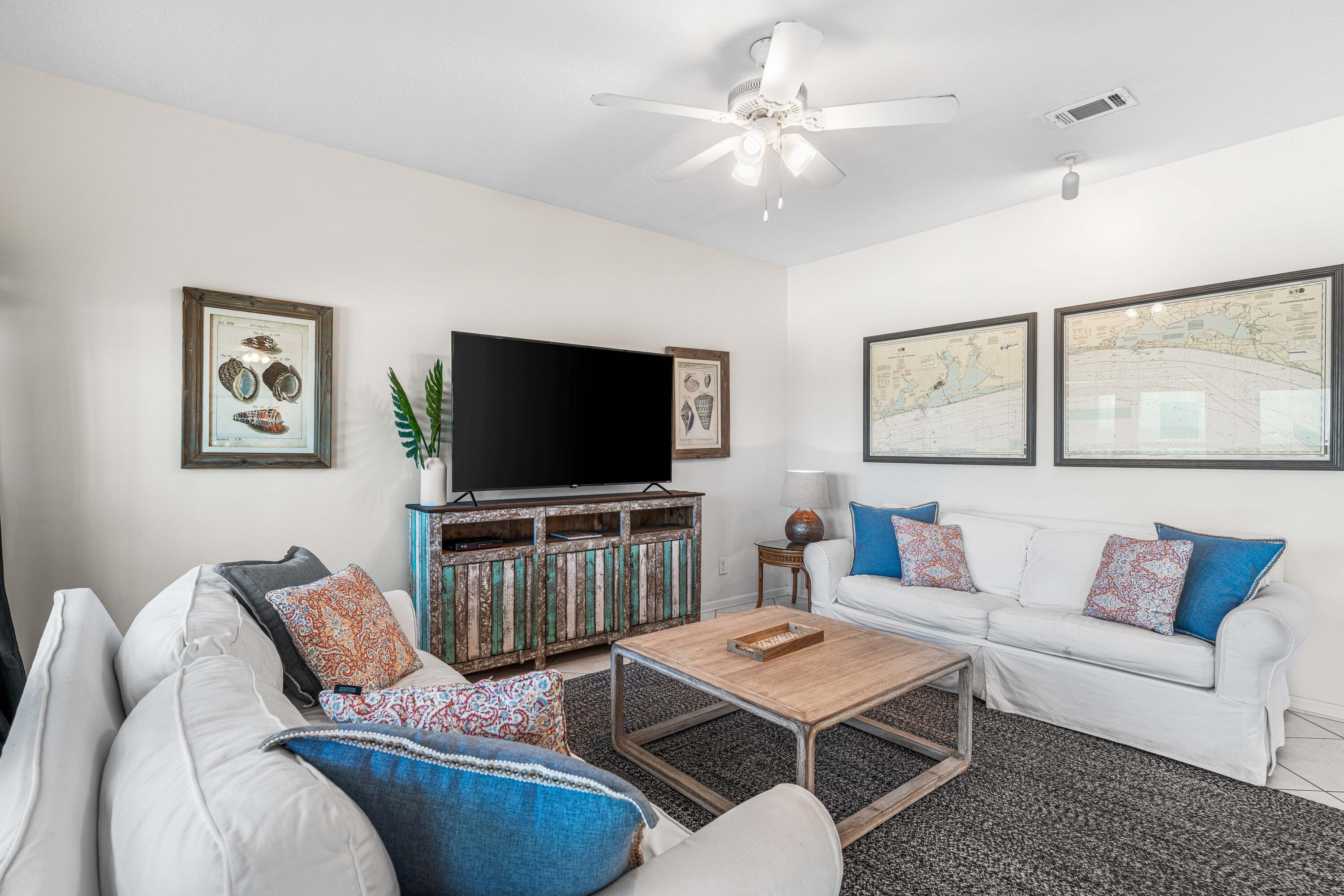 142 Beachside Drive, Unit 7 Santa Rosa Beach, FL 32459 - Photo 7 of 41 a living room with furniture and a flat screen tv