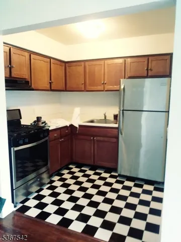 a kitchen with a refrigerator and cabinets