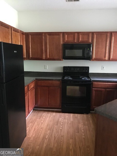 2320 Coach Way Jonesboro, GA 30236 - Photo 3 of 6 a kitchen with stainless steel appliances granite countertop a stove a refrigerator and a microwave